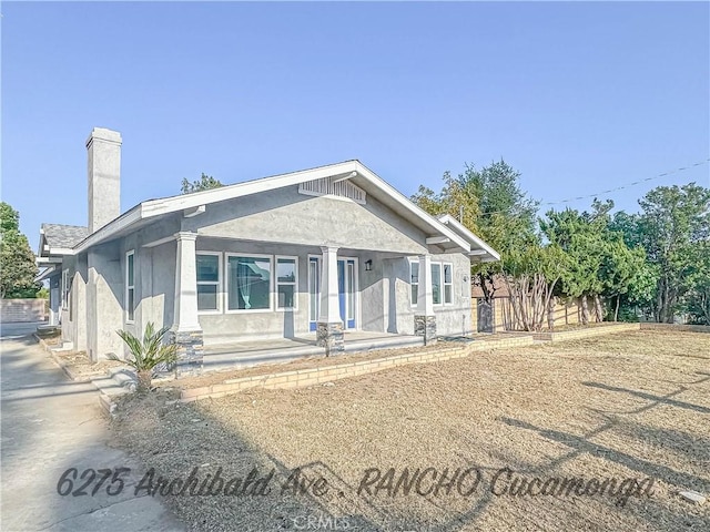 6275 Archibald Ave, Rancho Cucamonga, CA 91737 - view of front of property featuring stucco siding, covered porch, and a chimney