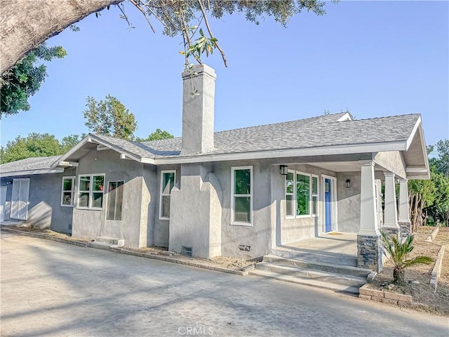 6275 Archibald Ave, Rancho Cucamonga, CA 91737 - ranch-style house featuring a chimney, stucco siding, roof with shingles, and a porch
