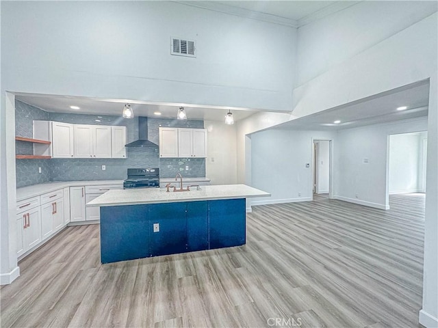 6275 Archibald Ave, Rancho Cucamonga, CA 91737 - kitchen with wall chimney range hood, range with electric stovetop, open shelves, white cabinetry, and a towering ceiling