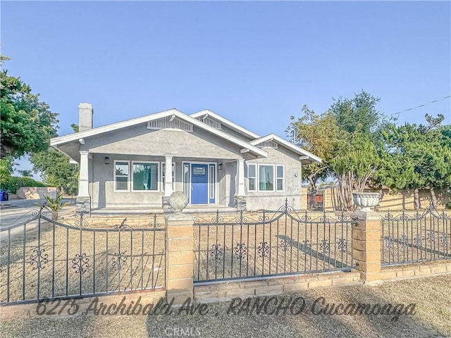 6275 Archibald Ave, Rancho Cucamonga, CA 91737 - view of front facade with covered porch, a fenced front yard, and stucco siding