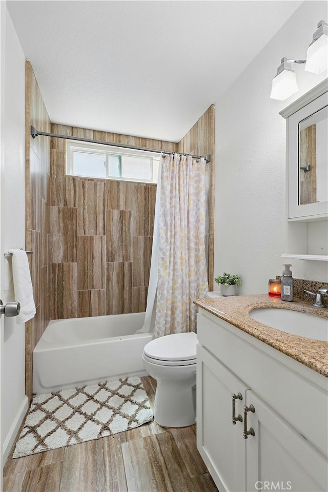 395 Columbia Ave, Merced, CA 95340 - full bathroom featuring vanity, shower / bath combo with shower curtain, toilet, and wood finished floors