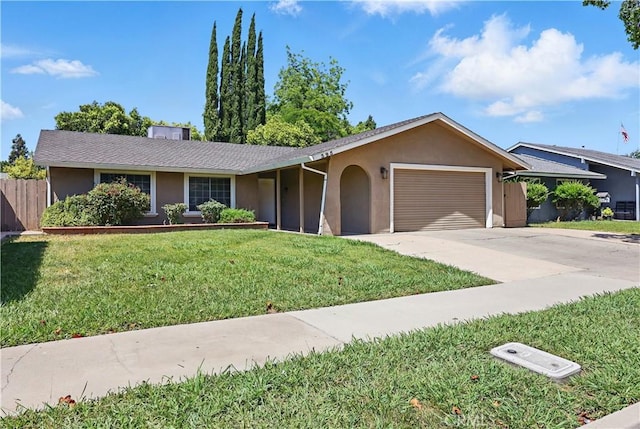 395 Columbia Ave, Merced, CA 95340 - ranch-style house with stucco siding, an attached garage, and concrete driveway