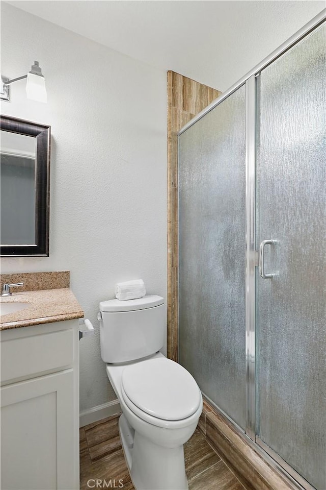 395 Columbia Ave, Merced, CA 95340 - bathroom with vanity, wood finished floors, toilet, and a shower stall