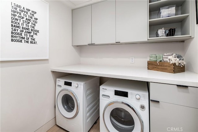 68 E F St, Encinitas, CA 92024 - laundry room featuring washing machine and clothes dryer and cabinet space