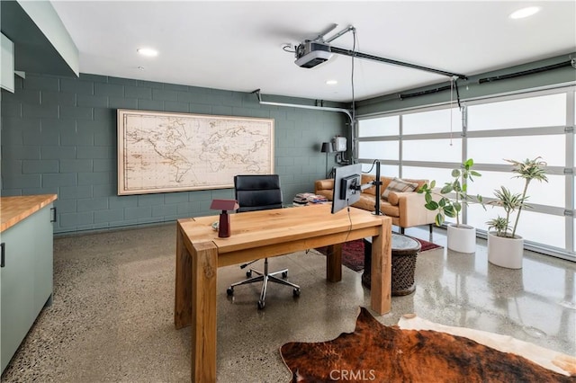 68 E F St, Encinitas, CA 92024 - office area featuring concrete block wall, recessed lighting, speckle patterned floor, and a garage