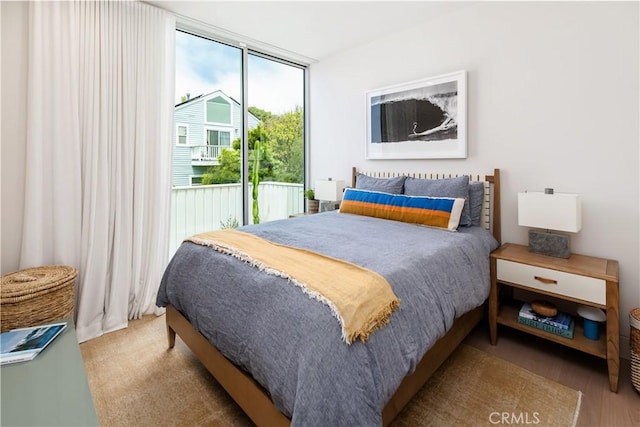 68 E F St, Encinitas, CA 92024 - bedroom featuring access to exterior and wood finished floors