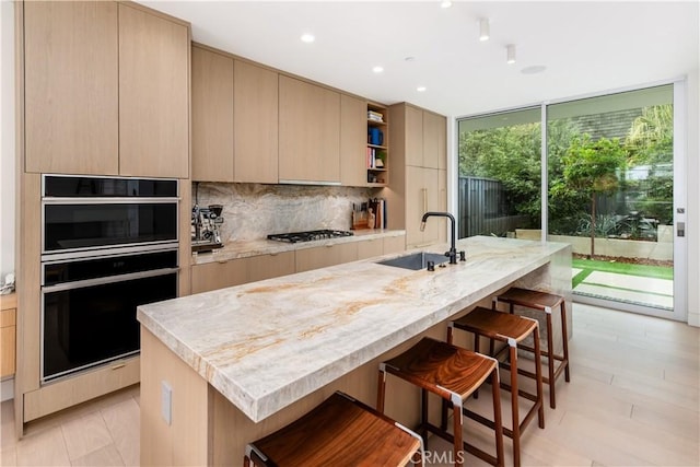 68 E F St, Encinitas, CA 92024 - kitchen featuring a sink, modern cabinets, open shelves, a kitchen bar, and backsplash