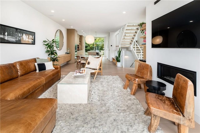 68 E F St, Encinitas, CA 92024 - living room featuring stairs, a glass covered fireplace, recessed lighting, and light wood-style floors