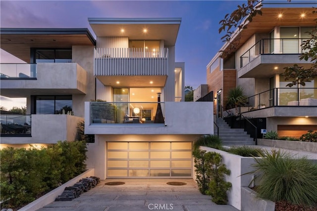 68 E F St, Encinitas, CA 92024 - contemporary home featuring a balcony, concrete driveway, an attached garage, and stairway