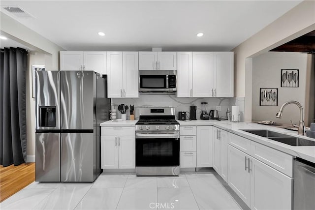 254 Piedmont Ave, Claremont, CA 91711 - kitchen with stainless steel appliances, a sink, white cabinets, recessed lighting, and tasteful backsplash