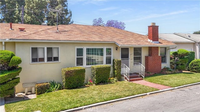 7933 Rhea Vista Dr, Whittier, CA 90602 - view of front of house with a chimney, a front lawn, stucco siding, and roof with shingles