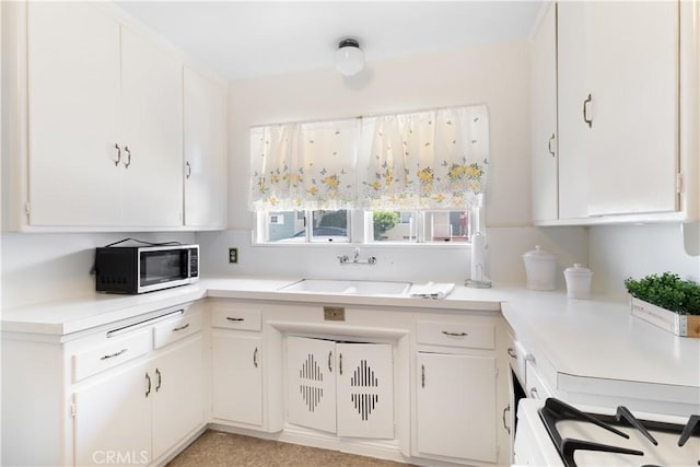 7933 Rhea Vista Dr, Whittier, CA 90602 - kitchen with stainless steel microwave, a sink, light countertops, stove, and white cabinets