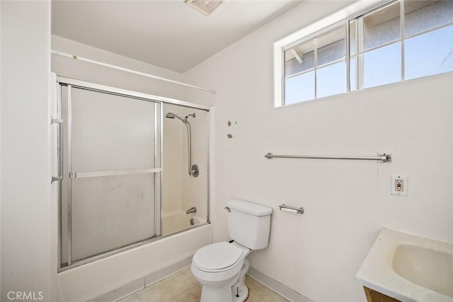 639 S 7th St, Grover Beach, CA 93433 - full bathroom with toilet, vanity, bath / shower combo with glass door, baseboards, and tile patterned flooring