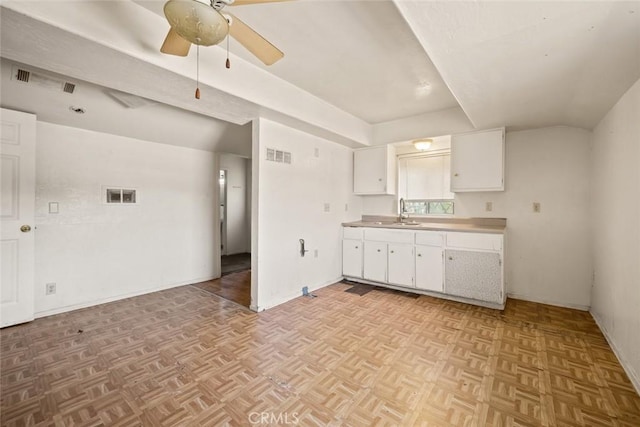639 S 7th St, Grover Beach, CA 93433 - kitchen with white cabinetry, a sink, light countertops, a ceiling fan, and baseboards