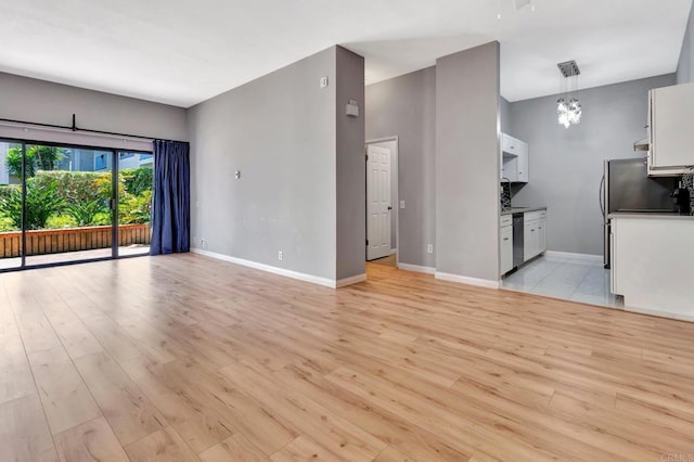 8328 Regents Rd Unit 1D, San Diego, CA 92122 - unfurnished living room featuring light wood-style flooring and baseboards