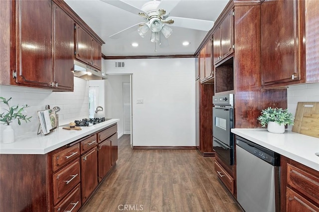 16432 Mcrae Ave, Norwalk, CA 90650 - kitchen with dishwasher, wall oven, under cabinet range hood, a ceiling fan, and decorative backsplash