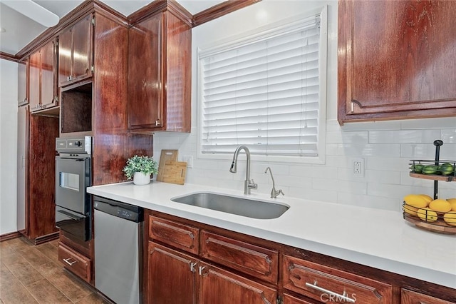 16432 Mcrae Ave, Norwalk, CA 90650 - kitchen with stainless steel appliances, a sink, light countertops, and tasteful backsplash