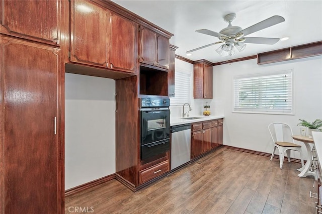 16432 Mcrae Ave, Norwalk, CA 90650 - kitchen with black oven, dishwasher, a sink, a warming drawer, and ceiling fan
