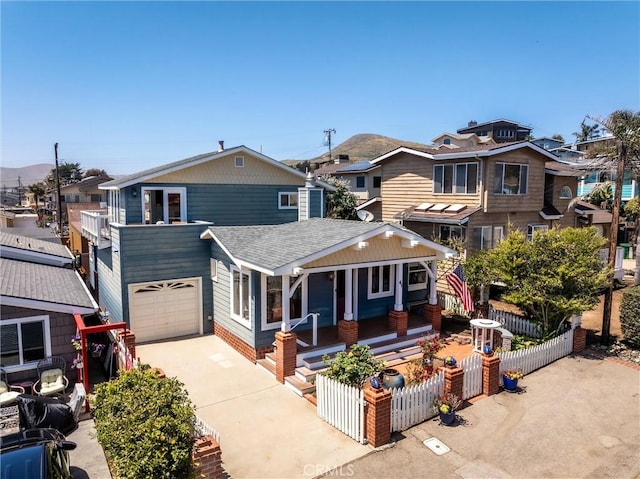 41 19th St, Cayucos, CA 93430 - view of front of home with a porch, roof with shingles, a garage, driveway, and a residential view