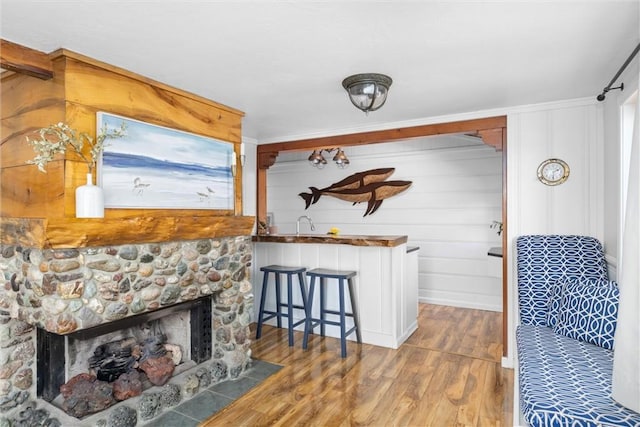 41 19th St, Cayucos, CA 93430 - living area featuring wood finished floors and a stone fireplace