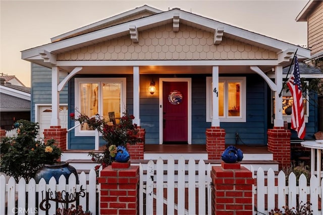 41 19th St, Cayucos, CA 93430 - bungalow featuring a porch, a fenced front yard, and a gate