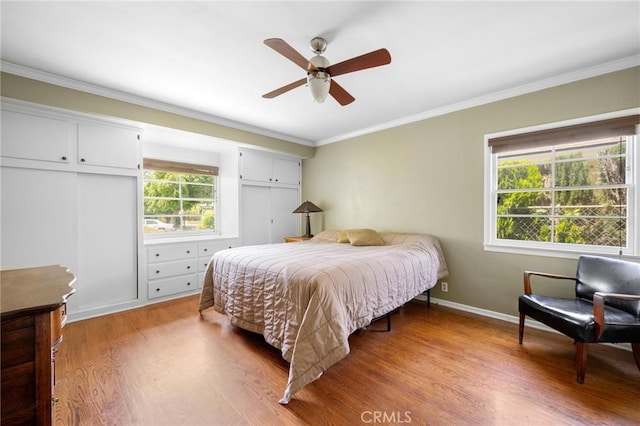 13617 Bassett St, Valley Glen, CA 91405 - bedroom featuring light wood-style floors, crown molding, ceiling fan, and two closets