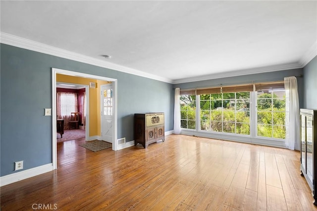13617 Bassett St, Valley Glen, CA 91405 - unfurnished living room featuring crown molding, hardwood / wood-style flooring, and plenty of natural light
