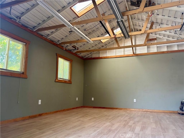 13617 Bassett St, Valley Glen, CA 91405 - unfurnished room with a skylight, wood finished floors, plenty of natural light, and lofted ceiling