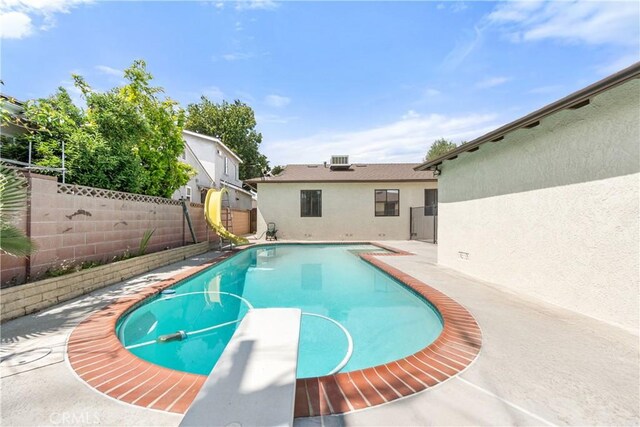 11676 Chesterton St, Norwalk, CA 90650 - view of pool featuring a fenced backyard, a diving board, a water slide, and a patio area