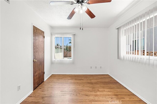 11676 Chesterton St, Norwalk, CA 90650 - empty room with wood finished floors, a ceiling fan, and baseboards