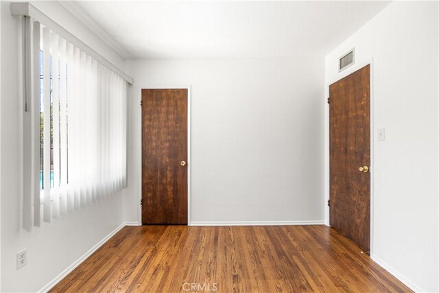 11676 Chesterton St, Norwalk, CA 90650 - unfurnished room with wood finished floors and baseboards