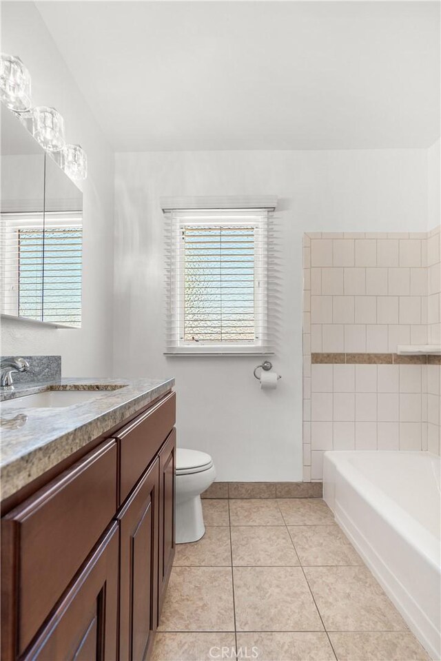 11676 Chesterton St, Norwalk, CA 90650 - full bath featuring toilet, vanity, a bath, tile patterned floors, and baseboards