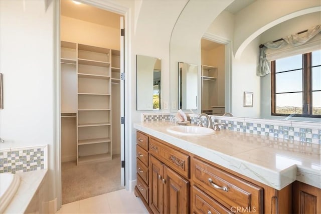 1470 Via Chaparral, Fallbrook, CA 92028 - bathroom featuring tile patterned flooring, vanity, a bath, a walk in closet, and decorative backsplash