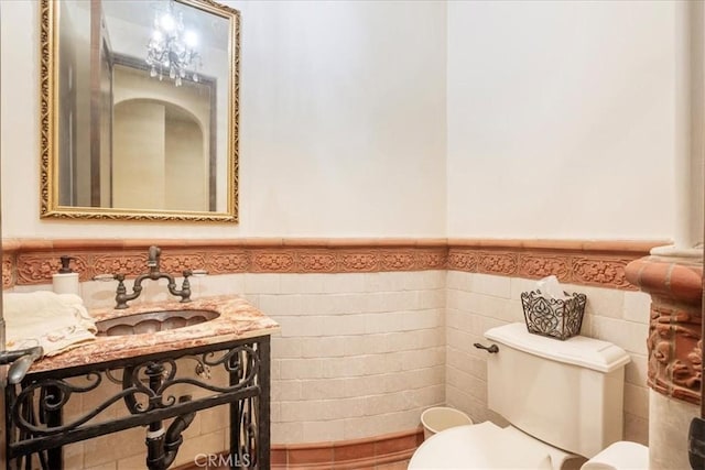 1470 Via Chaparral, Fallbrook, CA 92028 - half bathroom featuring a sink, toilet, wainscoting, and tile walls