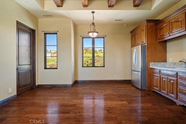 1470 Via Chaparral, Fallbrook, CA 92028 - kitchen featuring freestanding refrigerator, dark wood-style floors, brown cabinetry, hanging light fixtures, and light stone counters