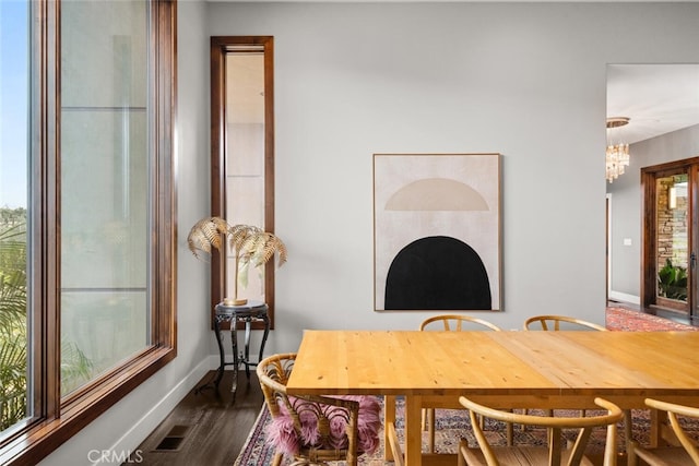 3386 Canyon Oaks Ter, Chico, CA 95928 - dining room featuring baseboards, dark wood finished floors, and a chandelier
