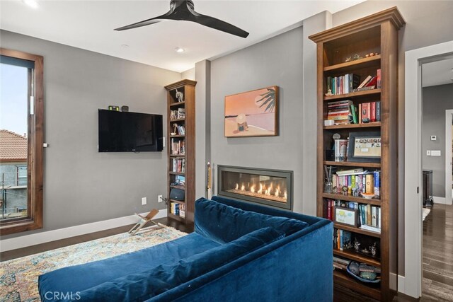 3386 Canyon Oaks Ter, Chico, CA 95928 - living room featuring wood finished floors, baseboards, a glass covered fireplace, a ceiling fan, and built in features