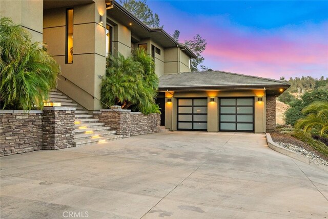 3386 Canyon Oaks Ter, Chico, CA 95928 - view of front facade featuring concrete driveway, stucco siding, stairway, and a garage