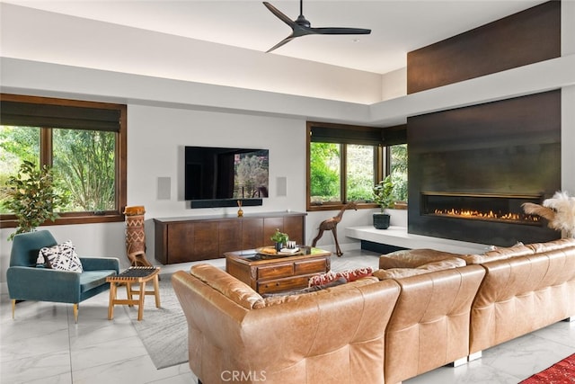 3386 Canyon Oaks Ter, Chico, CA 95928 - living room with light marble finish floors, a ceiling fan, and a glass covered fireplace
