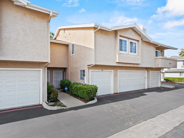1465 E Lexington Ave Unit 11C, El Cajon, CA 92019 - townhome / multi-family property featuring a garage, a chimney, and stucco siding