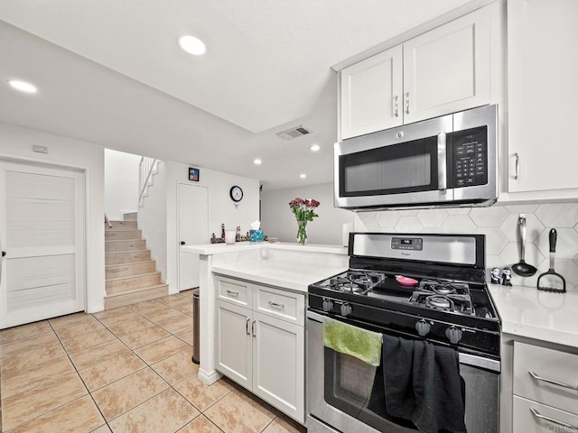 1465 E Lexington Ave Unit 11C, El Cajon, CA 92019 - kitchen with appliances with stainless steel finishes, a peninsula, light countertops, decorative backsplash, and recessed lighting