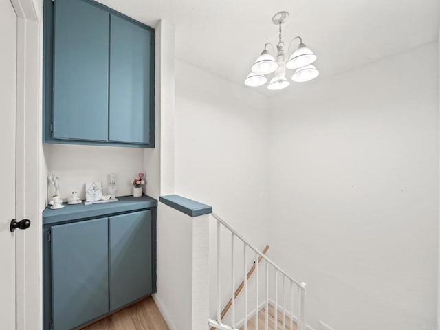 1465 E Lexington Ave Unit 11C, El Cajon, CA 92019 - bar area featuring a chandelier, light wood finished floors, and decorative light fixtures