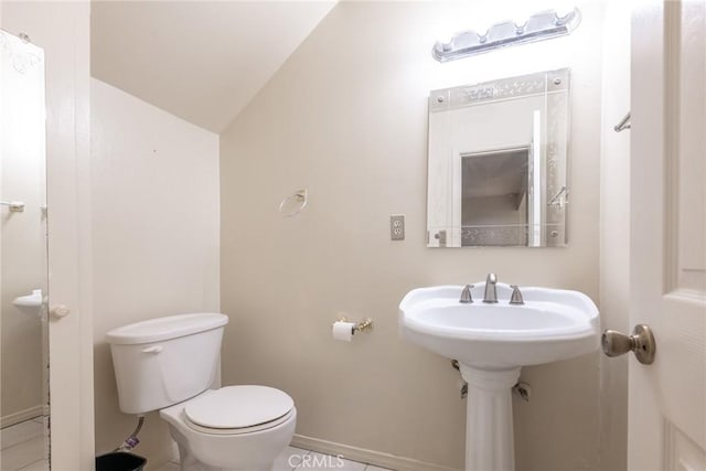 8804 Valley View St Unit C, Buena Park, CA 90620 - half bathroom featuring baseboards, toilet, lofted ceiling, and tile patterned flooring