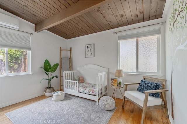 8521 Ranchito Ave, Panorama City, CA 91402 - bedroom featuring wood finished floors, wooden ceiling with exposed beams, a wall unit AC, and baseboards