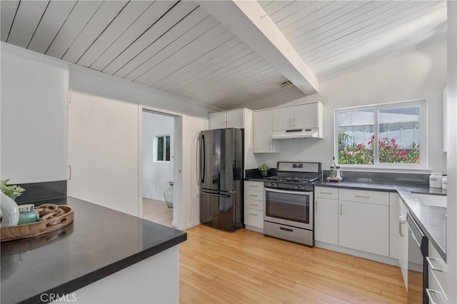 8521 Ranchito Ave, Panorama City, CA 91402 - kitchen featuring freestanding refrigerator, stainless steel gas stove, under cabinet range hood, dark countertops, and dishwashing machine