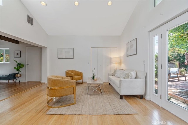 8521 Ranchito Ave, Panorama City, CA 91402 - living room featuring high vaulted ceiling, wood finished floors, and recessed lighting