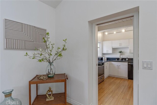 8521 Ranchito Ave, Panorama City, CA 91402 - hall featuring light wood-style floors and a sink