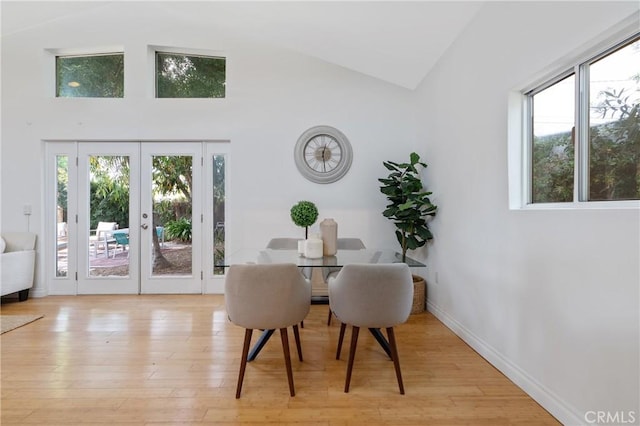 8521 Ranchito Ave, Panorama City, CA 91402 - dining area featuring french doors, light wood-type flooring, and high vaulted ceiling