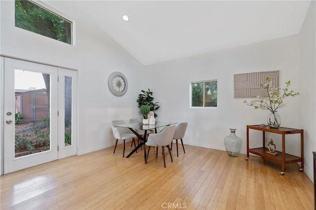8521 Ranchito Ave, Panorama City, CA 91402 - dining area featuring light wood finished floors, baseboards, and high vaulted ceiling