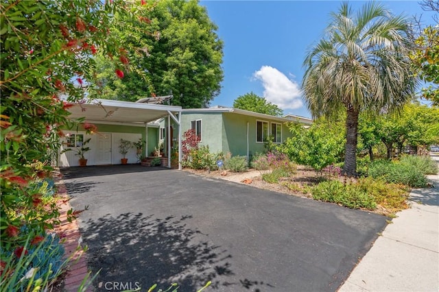 8521 Ranchito Ave, Panorama City, CA 91402 - view of front of property with driveway, stucco siding, and an attached carport